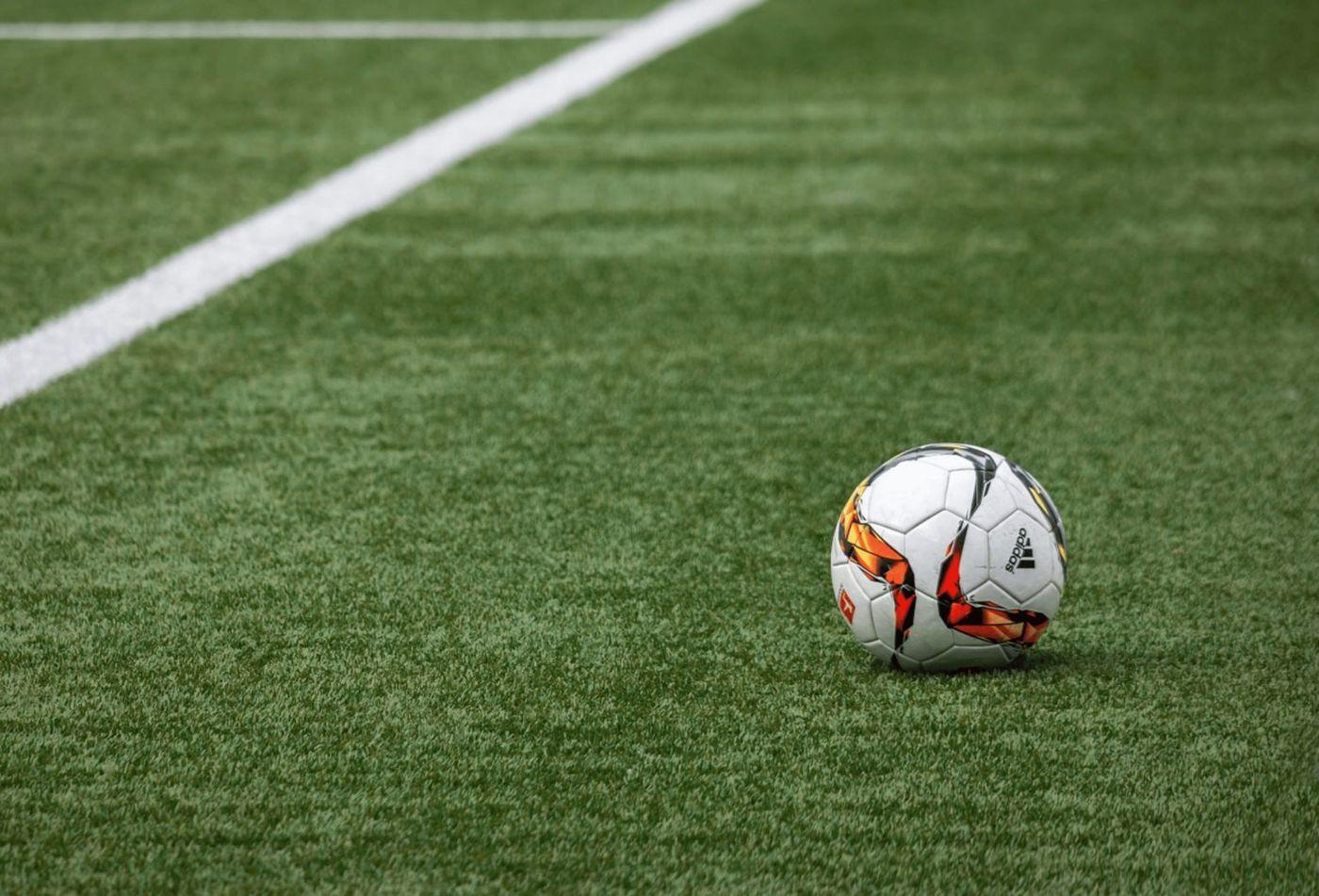 Artificial grass sports field with soccer ball